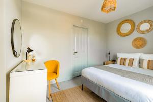 a bedroom with a bed and a desk and mirror at St James Lodge in Cheltenham