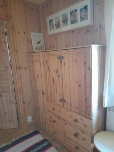 a bathroom with a wooden cabinet in a room at Letten in Brograngen