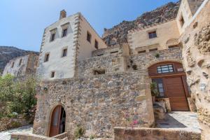 an old stone house on the side of a mountain at Pablito House in Monemvasia