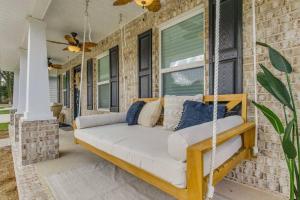 a porch with a swinging couch on a house at Retreat at the Oasis in Pensacola