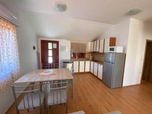 a kitchen with a table and a refrigerator at Apartment With the Sea View in Basina
