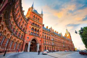 a large orange building with a clock tower at 2BD Kings Cross & St Pancras Elegance in London