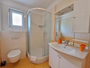 a bathroom with a shower and a toilet and a sink at Apartments Maslina in Baška