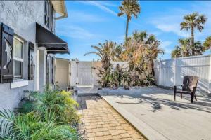 a patio with a bench and a fence at Summer Sands Lodge Unit3 in Flagler Beach
