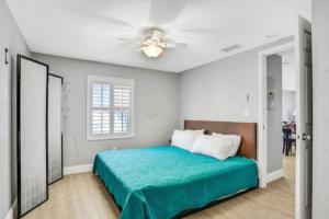 a bedroom with a bed and a ceiling fan at Summer Sands Lodge Unit3 in Flagler Beach