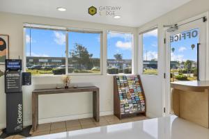 a store front with windows and a counter with a table at Gateway Lodge in Seaside