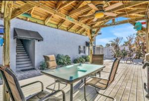 a patio with a table and chairs under a wooden pergola at Summer Sands Lodge Unit3 in Flagler Beach