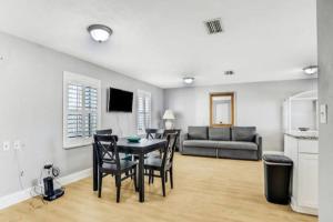 a living room with a table and chairs and a couch at Summer Sands Lodge Unit3 in Flagler Beach