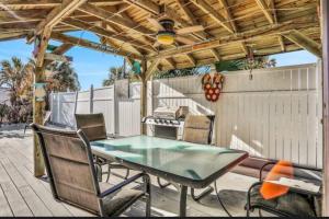 a patio with a table and chairs and a grill at Summer Sands Lodge Unit3 in Flagler Beach +40 photos