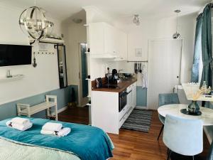 a small room with a bed and a kitchen at Marcel Zadar City Center in Zadar
