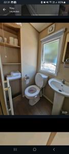a picture of a bathroom with a toilet and a sink at Oakley in Rookley