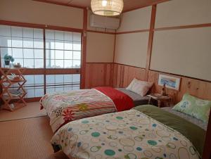 Postel nebo postele na pokoji v ubytování しまなみ海道お宿ぽんぽこ