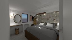 a bedroom with a large bed and a brick wall at Casa Napais Luxury Private Villa in Archangelos