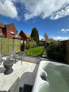 eine Badewanne auf einer Terrasse mit einem Hof in der Unterkunft Sam in Bolton