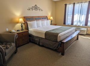 a bedroom with a large bed and a window at Travelodge by Wyndham Deadwood in Deadwood