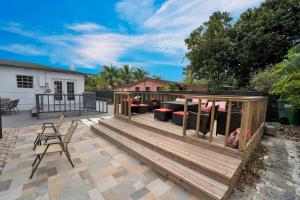 a wooden deck with furniture on a patio at Miami stays vacations in Miami