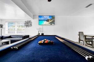 a living room with a pool table in the middle at Miami stays vacations in Miami