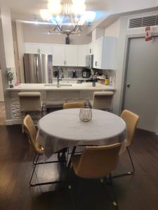 a kitchen with a table and chairs and a kitchen with a counter at Wissem in Edmonton