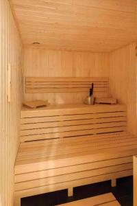 a wooden sauna with a bench in it at L11 Warsaw Apartments in Warsaw