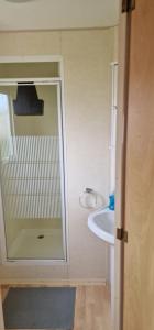 a bathroom with a sink and a mirror at Caravan near Port Carlisle in Aikton