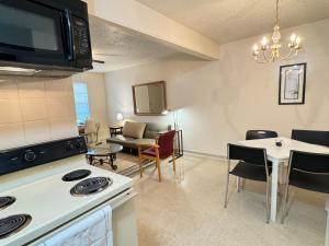 a kitchen and living room with a table and a microwave at 1326-#3 downtown comfy & clean 1bedroom unit in San Antonio