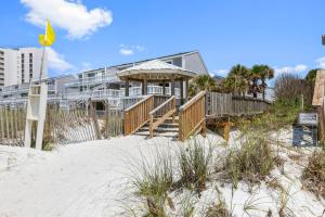a house on the beach next to the sand at New Luxury Listing! Walking distance to shops, lake & beach in Destin