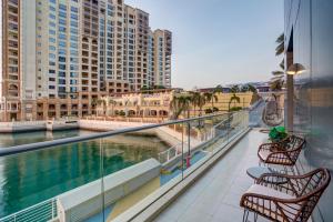 a balcony with chairs and a view of the water at Oceana Atlantic Seaside Apt in Dubai