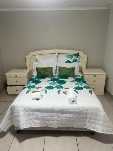 - une chambre avec un grand lit et des serviettes dans l'établissement Triple T Guest house, à Johannesbourg