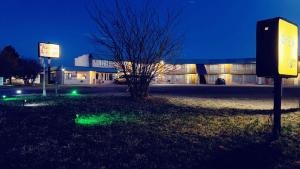 a sign in front of a building at night at Travelors Lodge Motel & RV Park US-287&US-96 in Eads