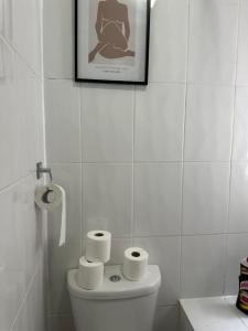 a bathroom with a toilet with three rolls of toilet paper at Amazing Ground Floor one bedroom apartment Forest Road in London