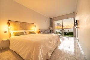 a bedroom with a bed and a view of the ocean at El 5º Cielo in Las Palmas de Gran Canaria +25 photos