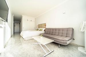 a living room with a couch and a bed at El 5º Cielo in Las Palmas de Gran Canaria