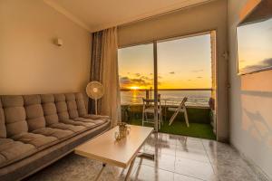 a living room with a couch and a view of the ocean at El 5º Cielo in Las Palmas de Gran Canaria