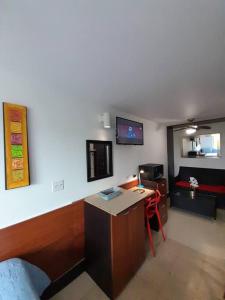 ein Wohnzimmer mit einem Schreibtisch und ein Zimmer in der Unterkunft R.1112 Estudio ejecutivo, privado con cocina y baño. in Panama-Stadt