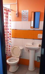 a bathroom with a toilet and a sink at PAKKARIN - HOTEL in Chachapoyas