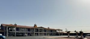 a building with cars parked in a parking lot at Days Inn by Wyndham Van Horn TX in Van Horn