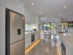 a kitchen with white counters and a large refrigerator at Luxurious home with pool and Water views in Gold Coast