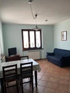 a living room with a table and chairs and a couch at Casa Vacanze Vecchio Frantoio Residenza Moraiolo in Spoleto