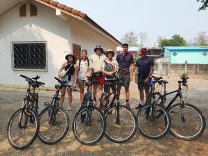 a group of people standing next to their bikes at Perfect Resort Sukhothai & motorbikes for rent & bicycles for rent in Sukhothai