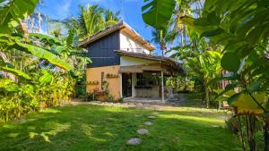 a house in the middle of a banana plantation at Tropical Haven with Dedicated Office Space in Siargao in General Luna