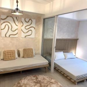 - une chambre avec 2 lits et une grande fenêtre dans l'établissement Great for Staycation for Family in Azure Beach, à Tanza
