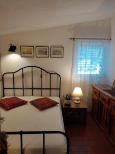 a bedroom with a bed and a table and a window at Seaside holiday house Podaca, Makarska - 22964 in Podaca