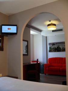 a living room filled with furniture and a tv at Complejos J-Enrimary in Puebla de Sanabria