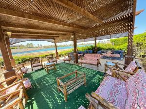 an outdoor patio with furniture and a view of the ocean at Villa marina 5 first row on lake 5 bed rooms ac in El Alamein