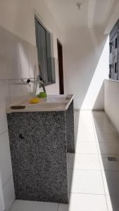 a bathroom with a counter with a sink in it at Jockey Family_Suave in Vila Velha