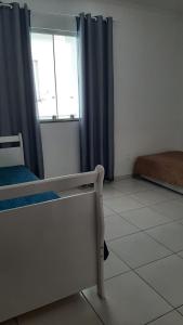 a hospital room with a bed and a window at Jockey Family_Suave in Vila Velha