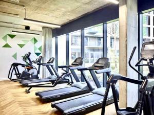 a gym with a bunch of cardio machines at 2bed Central Apartment + Gym + Pool in London