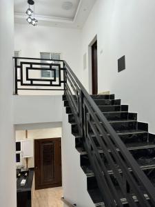 a staircase in a house with black railings at Dreams Resorts in Sinādil