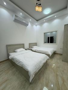 two beds in a white room with a mirror at Dreams Resorts in Sinādil