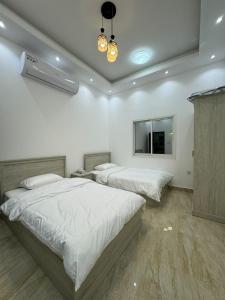 a bedroom with two beds and a flat screen tv at Dreams Resorts in Sinādil